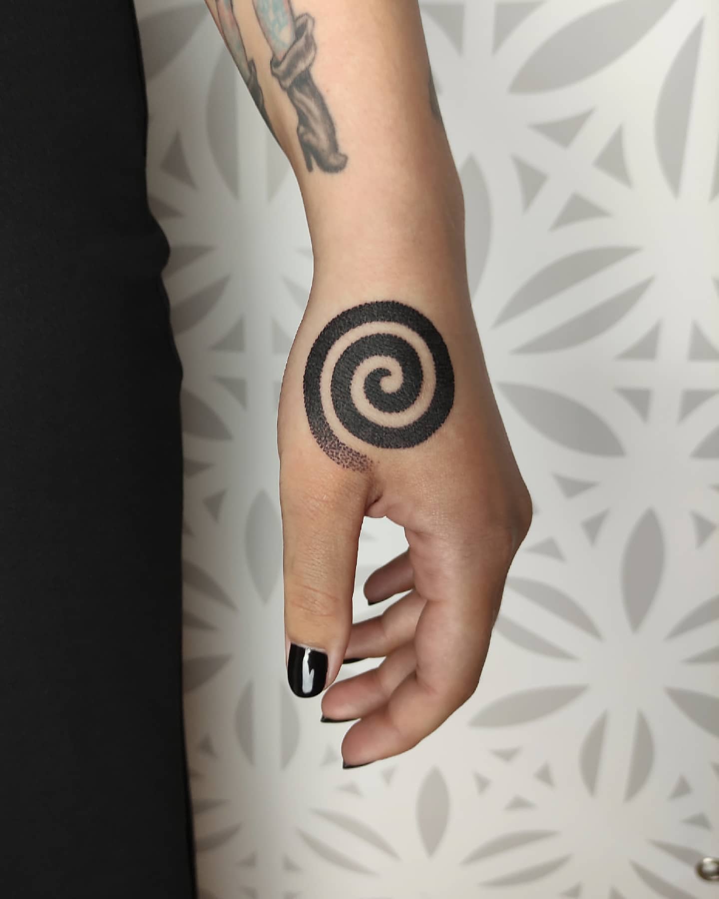 Spiral hand tattoo dotwork