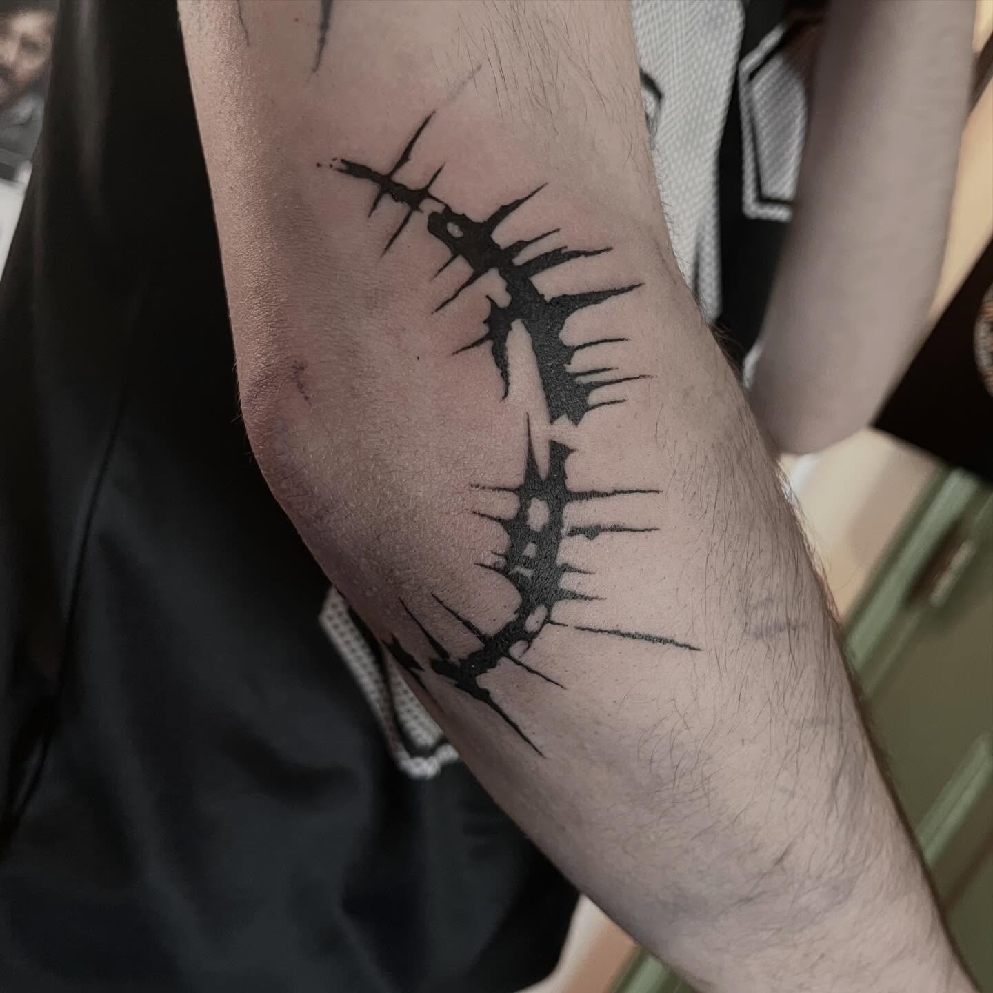 Abstract elbow tattoo